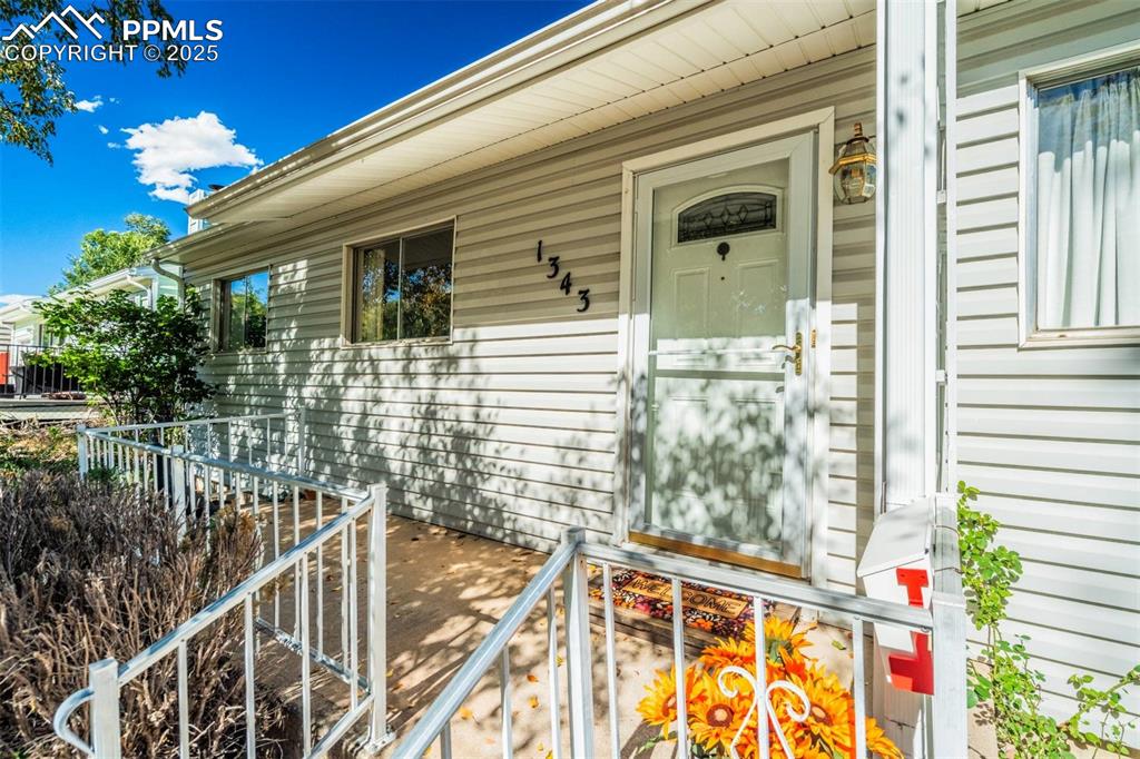 Image 3 of 47: Doorway to property with a porch