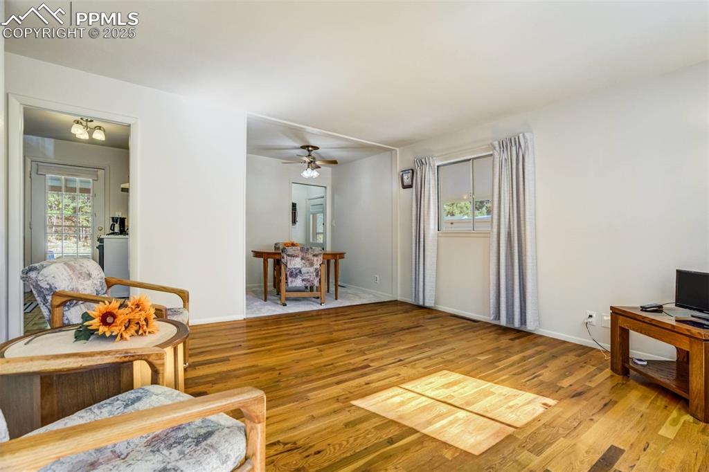 Image 4 of 47: Living area featuring light wood-style flooring and ceiling fan