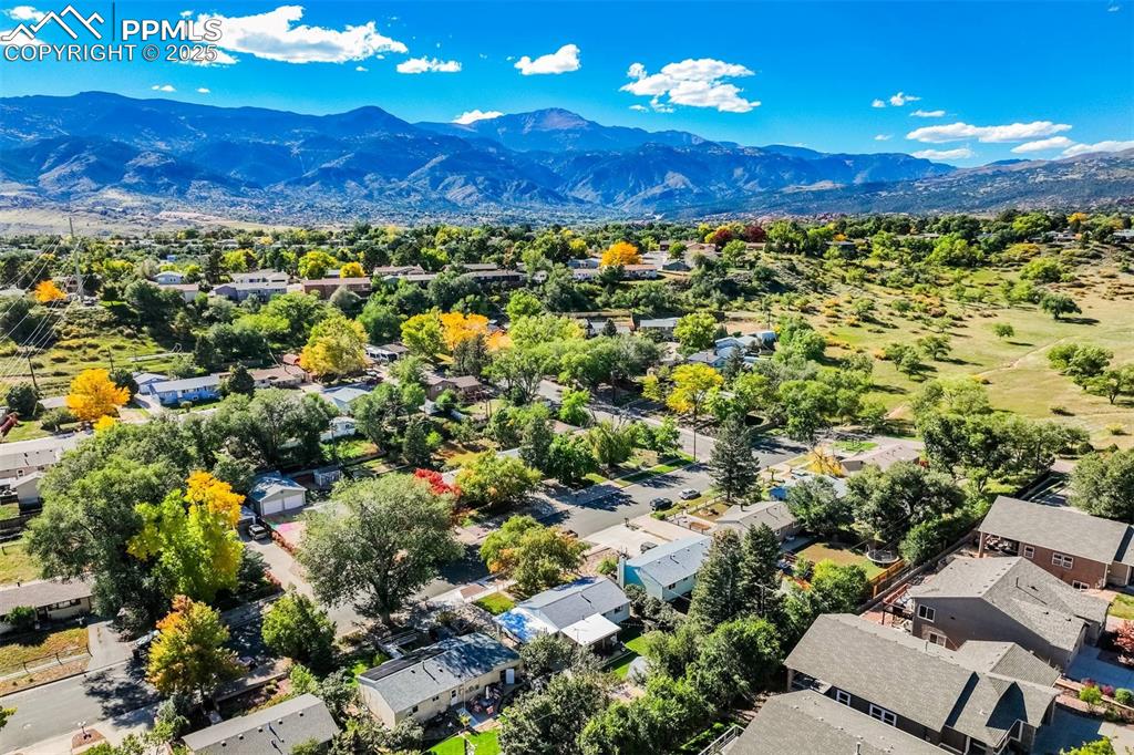 Image 45 of 47: Aerial perspective of suburban area with a mountainous background