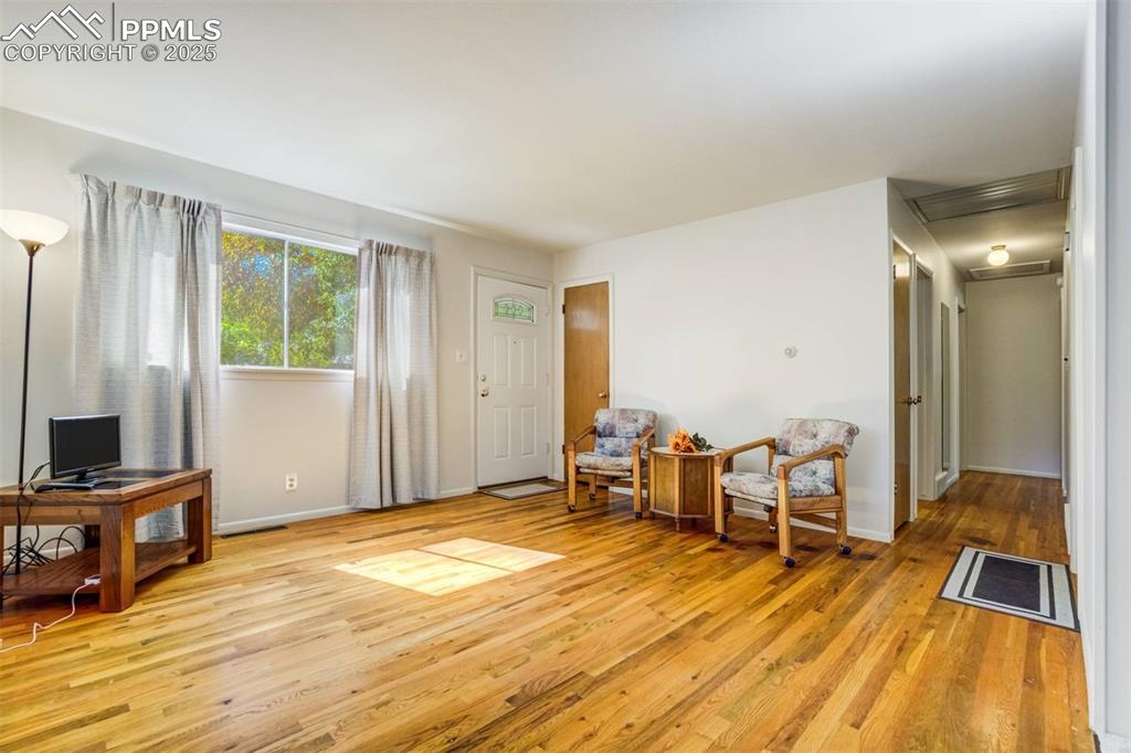 Image 5 of 47: Living area with light wood finished floors