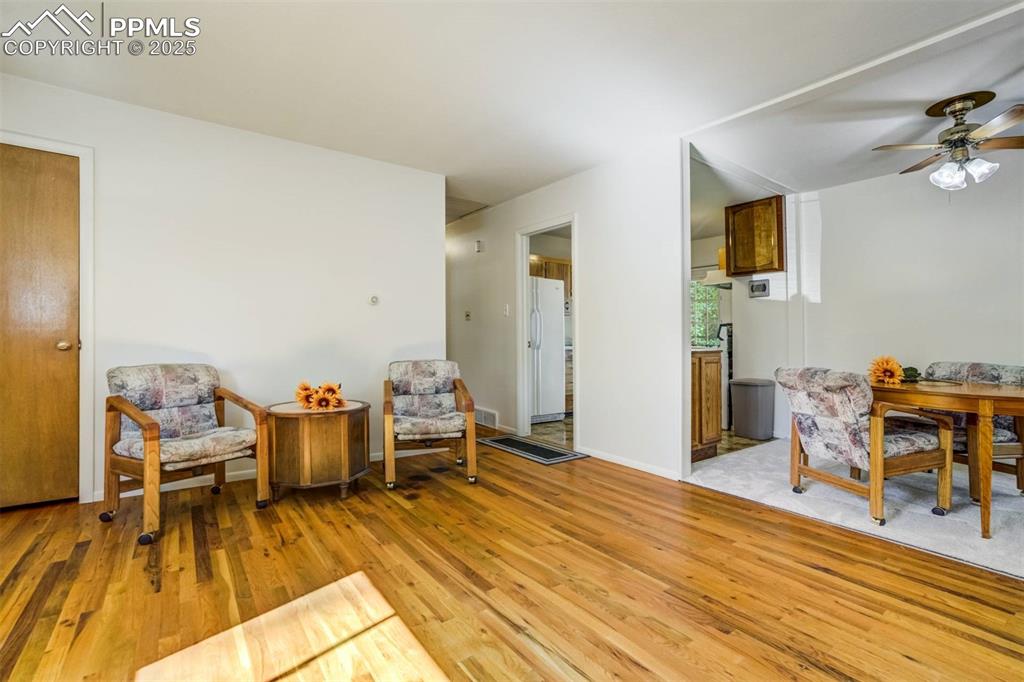 Image 7 of 47: Sitting room with light wood-type flooring and ceiling fan