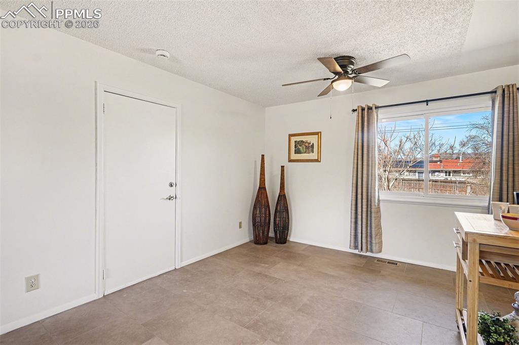 Image 6 of 21: New ceiling fans and updated lighting elevate every room