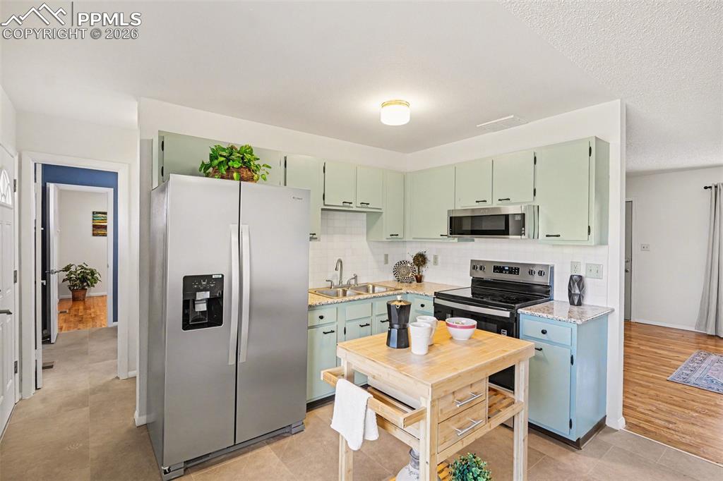 Image 8 of 21: Updated kitchen featuring new stainless steel appliances, new granite count