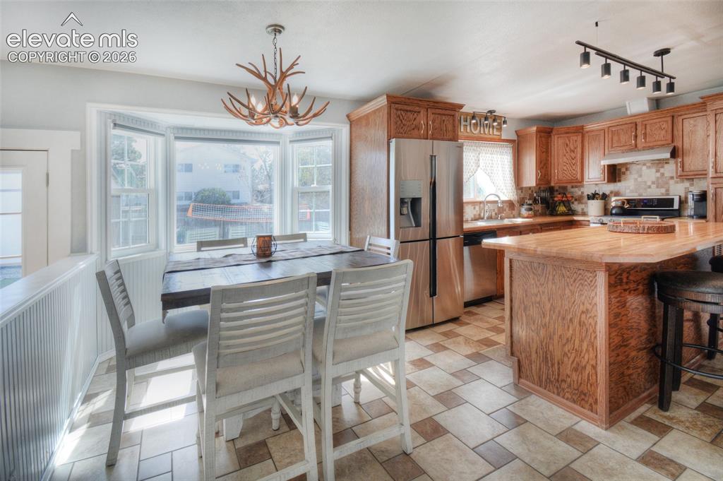 Image 11 of 26: Dining area and kitchen perfect for everyday meals and entertaining. Farm s