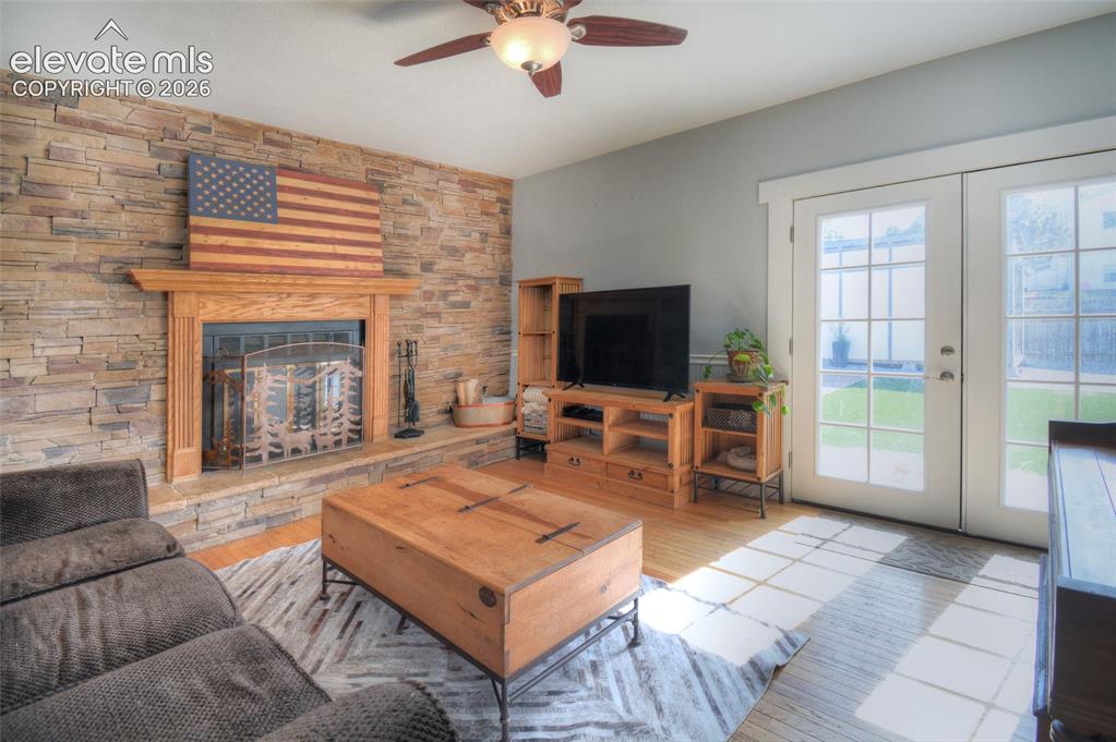Image 12 of 26: Wood burning fireplace with natural stone surround, wired for t.v. above fi