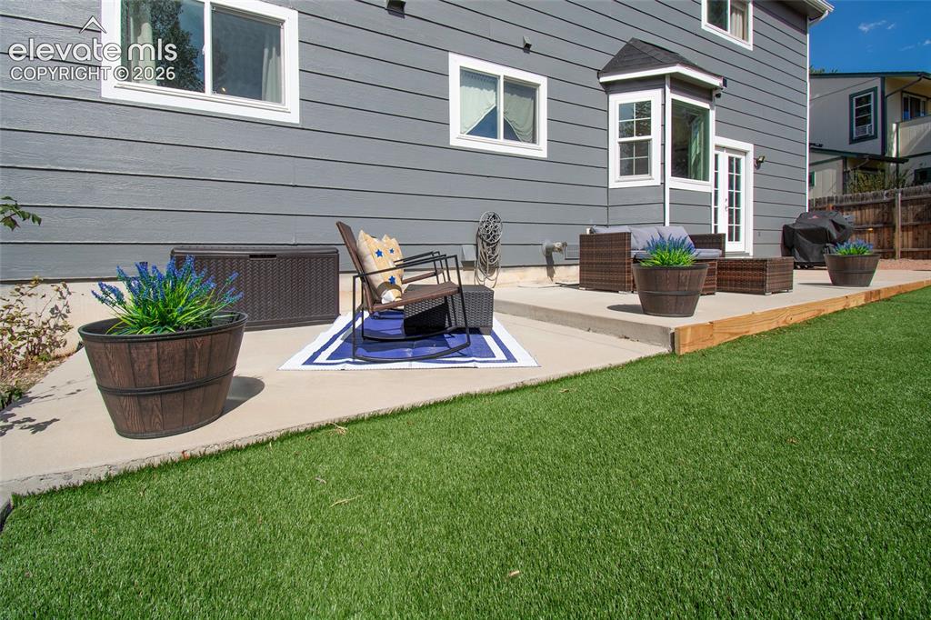 Image 13 of 26: Expansive 43 X 10 concrete back patio perfect for multiple seating areas, r