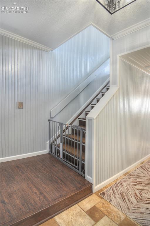 Image 15 of 26: LVP landing and stairs leading to upper level.