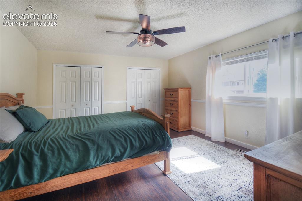 Image 21 of 26: 3rd upper level bedroom with LVP flooring and decorative ceiling fan with l