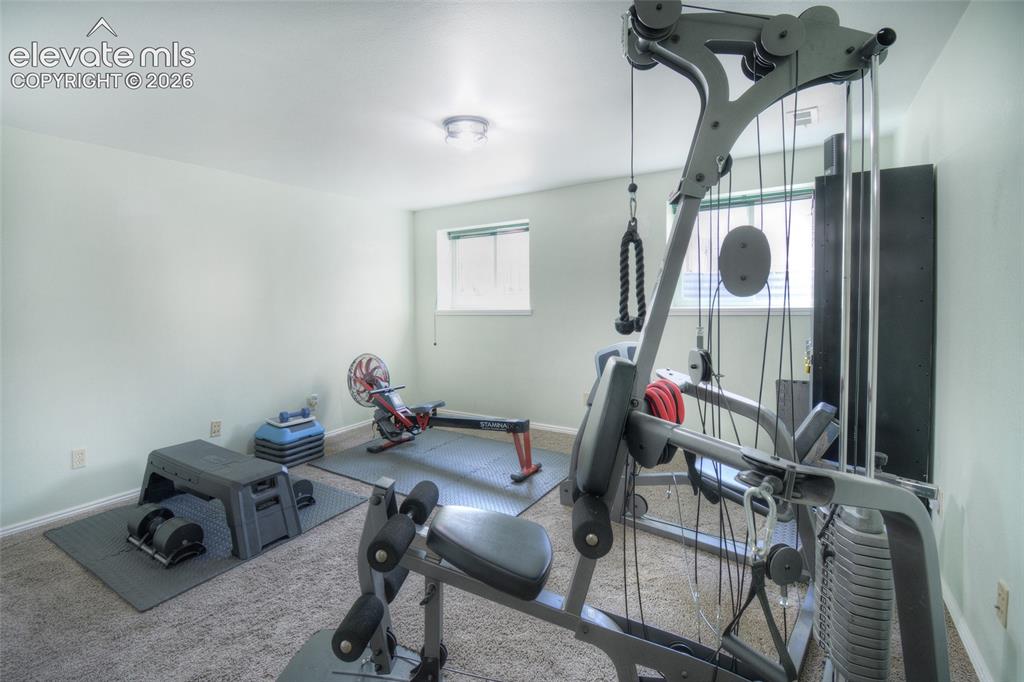 Image 24 of 26: Lower level bedroom currently purposed as a workout room.