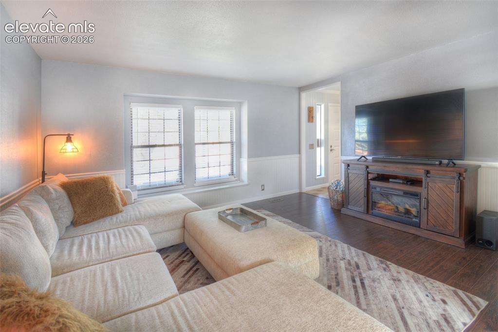 Image 5 of 26: Bright, inviting main-level living room just off the front entry, featuring