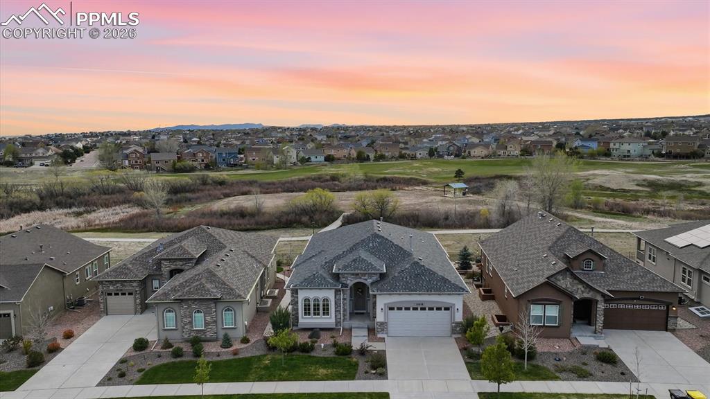 Image 2 of 50: Aerial view of home that backs to walking trails and Stonebridge Park.