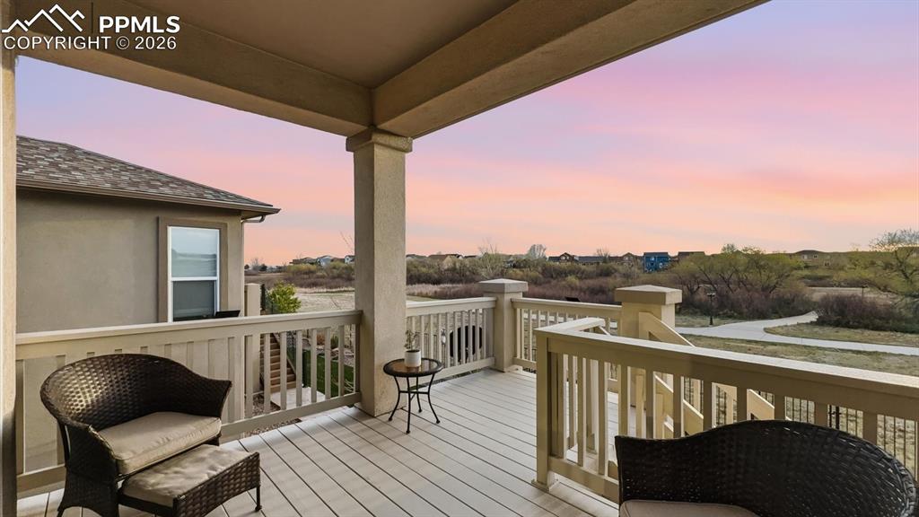 Image 21 of 50: Backyard covered wood
deck overlooking community walking trails and Stone
