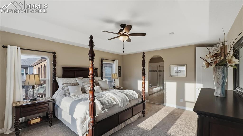 Image 25 of 50: The main level Primary Bedroom is a private retreat with a walk in closet a