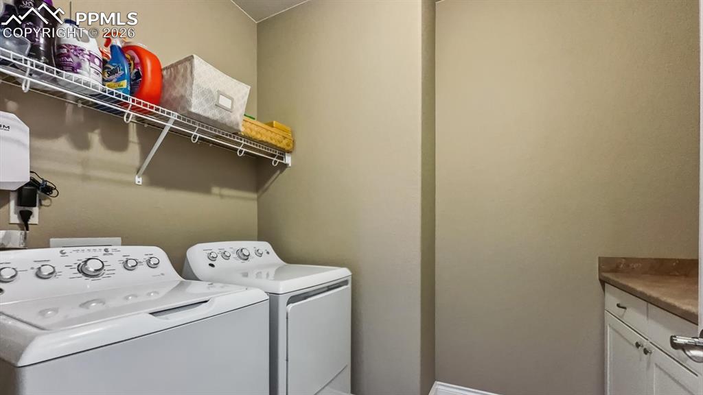 Image 28 of 50: The Laundry Room is located off the Primary Bedroom and includes cabinetry