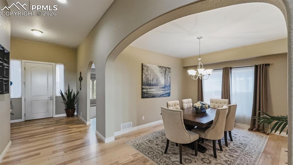 Image 3 of 50: Arched entry into the formal Dining Room, perfect for gatherings.