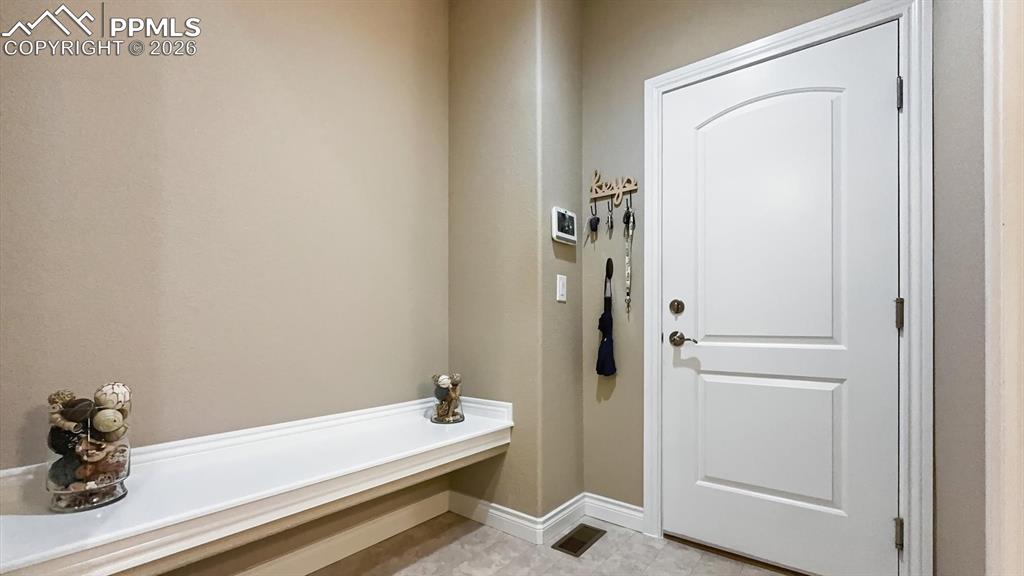 Image 30 of 50: Mud Room with bench seat and garage access.