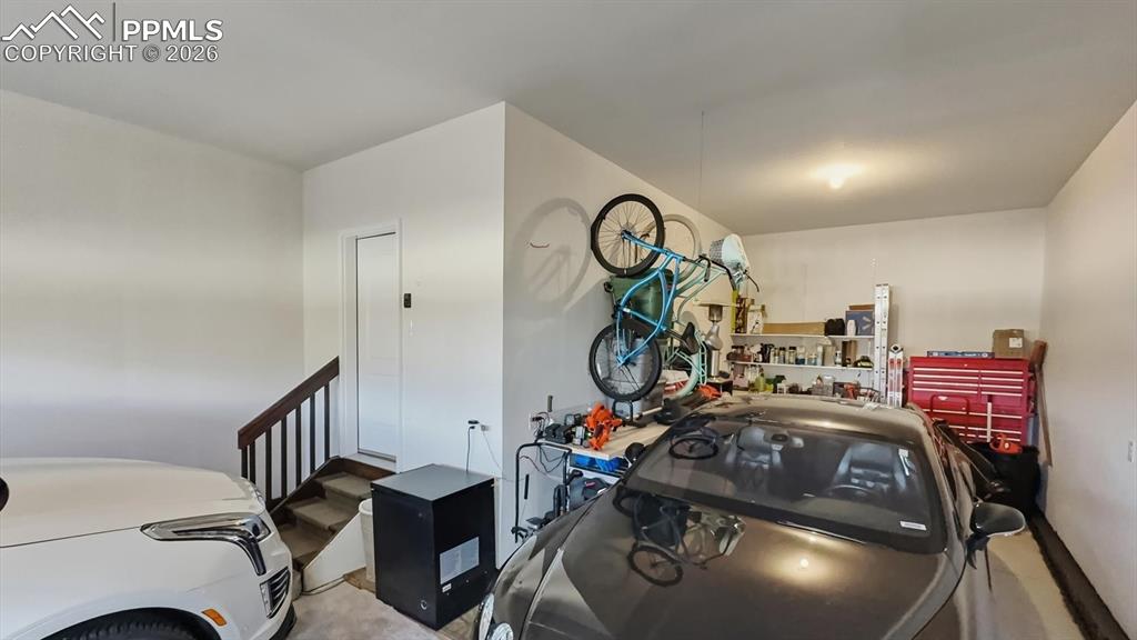 Image 31 of 50: 3-car attached tandem garage.