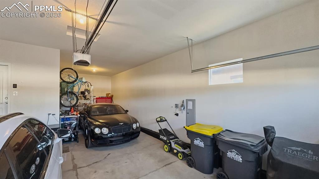 Image 32 of 50: Finished 3-car attached tandem garage with door opener.