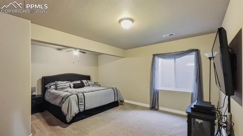 Image 33 of 50: Basement Bedroom Suite #3
with neutral carpet, walk in closet, and adjoin