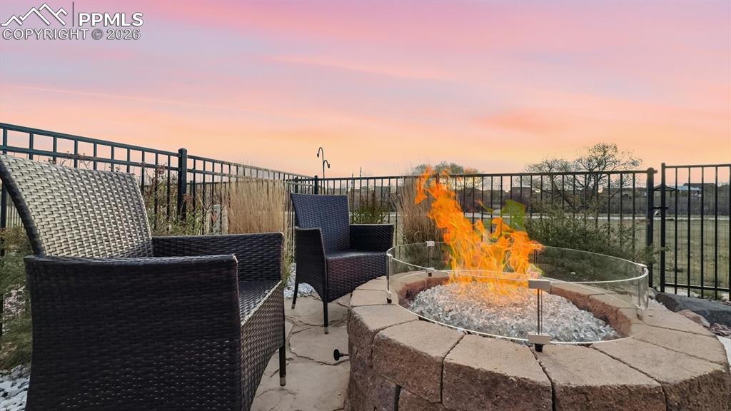 Image 49 of 50: Backyard flagstone patio with gas firepit included.