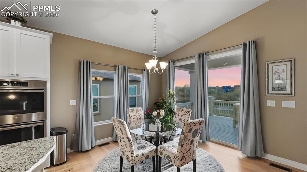 Image 6 of 50: Dining Nook for informal dining with slider to the backyard composite deck.