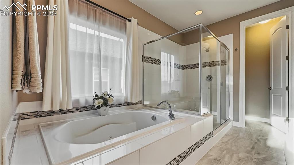Image 8 of 50: 5pc Primary Bathroom with jetted tub, separate tiled shower, and dual sink