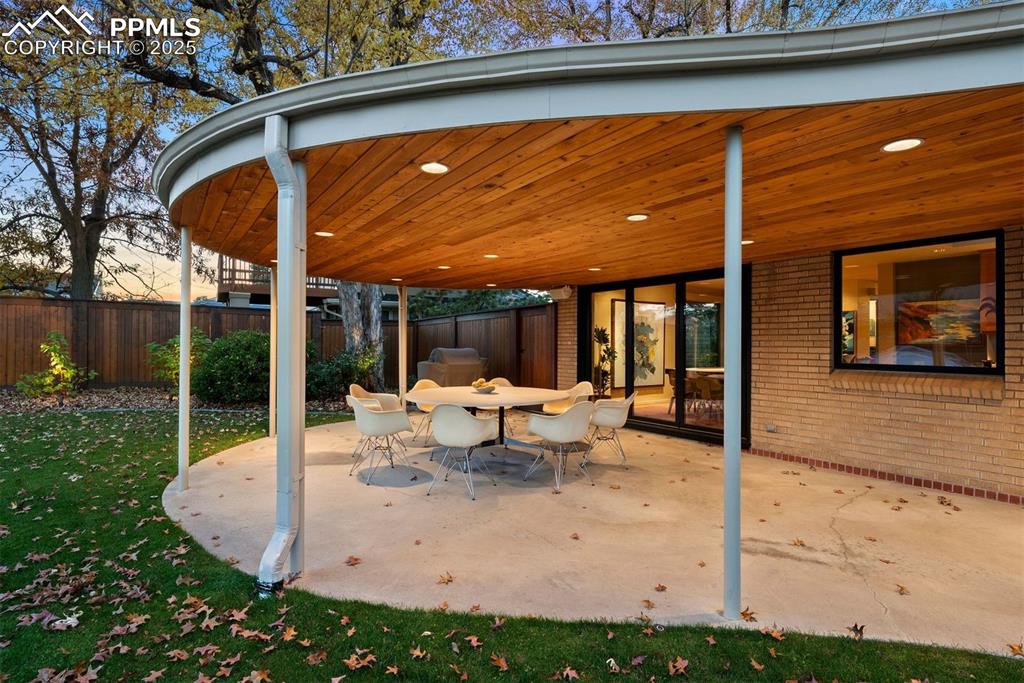 Image 7 of 44: Covered back patio with cedar tongue & groove ceiling. 