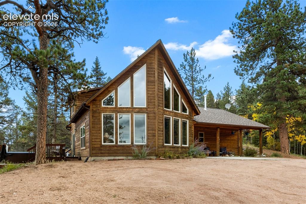 Image 1 of 50: Wood-sided exterior with an A-frame architectural style, featuring an expan