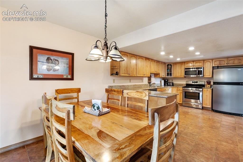 Image 29 of 50: Well-appointed kitchen featuring wood-finish cabinetry, stainless steel app