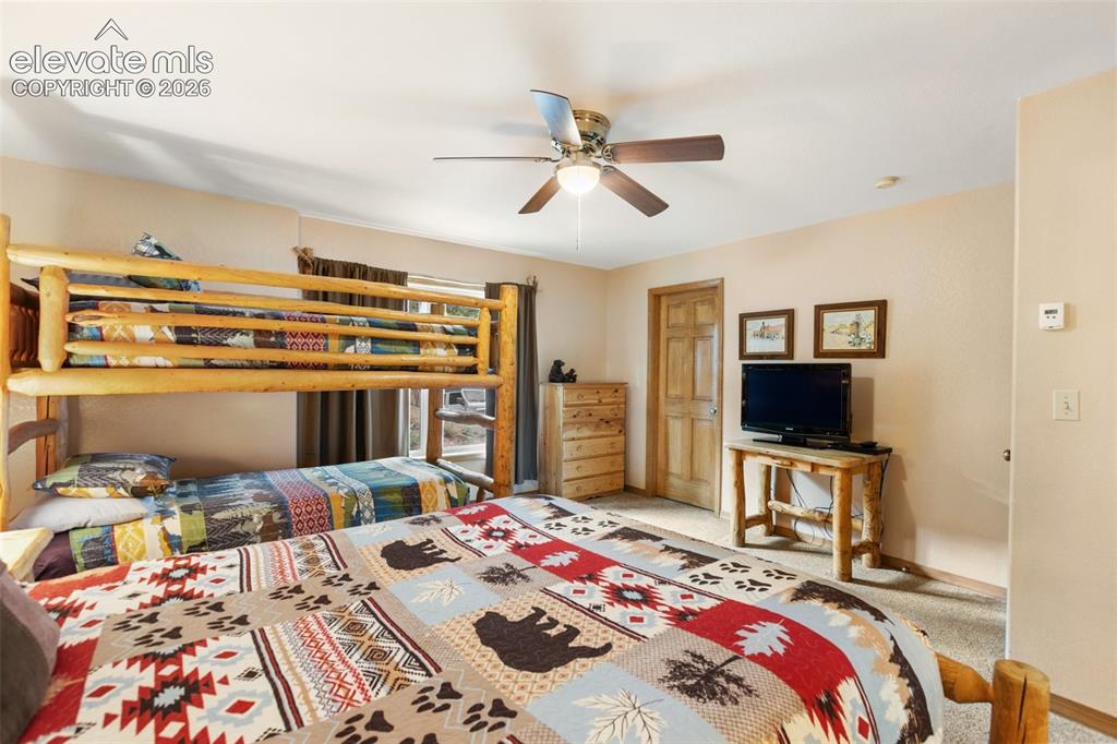 Image 34 of 50: Built-in bunk bed structure, wood-finish interior door, wood-finish dresser