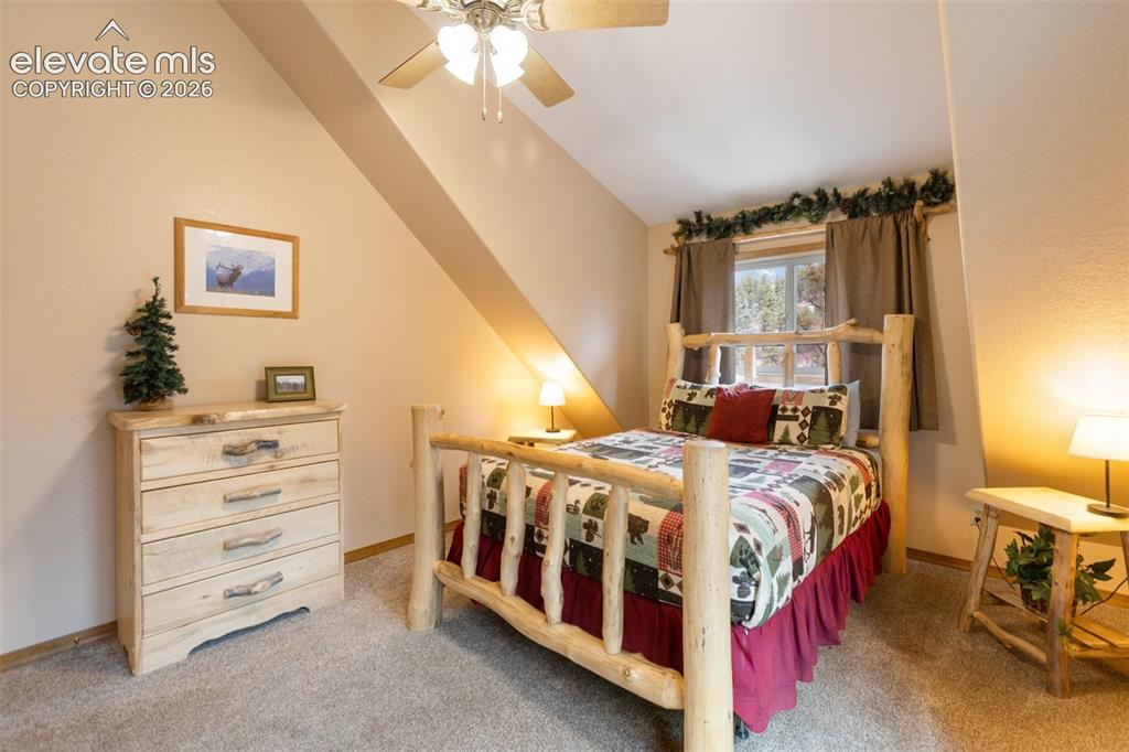 Image 38 of 50: Angled ceiling, recessed lighting, ceiling fan, window with curtains, carpe