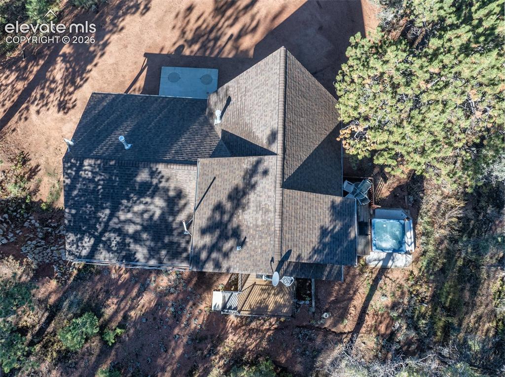 Image 50 of 50: Multi-level asphalt shingle roofline with multiple ventilation pipes