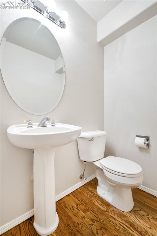 Image 18 of 47: Half bathroom with wood finished floors