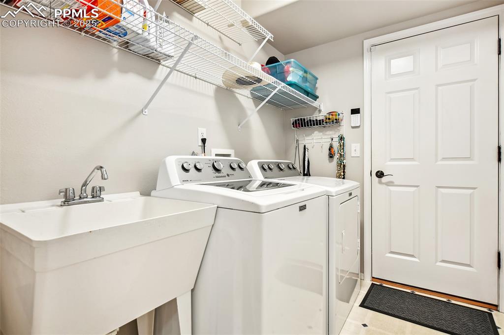 Image 19 of 47: Laundry area with washing machine and clothes dryer