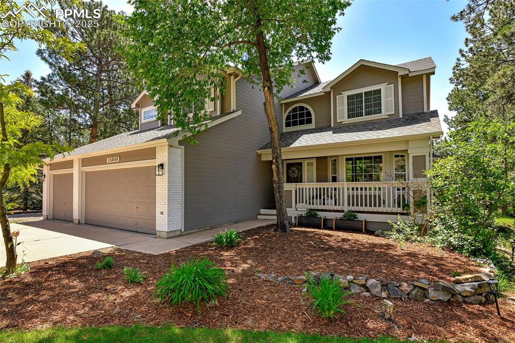 Image 3 of 47: View of front of house with a porch, concrete driveway, a shingled roof, br