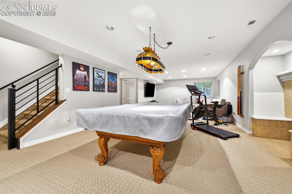 Image 33 of 47: Rec room featuring carpet, pool table, arched walkways, and recessed lighti
