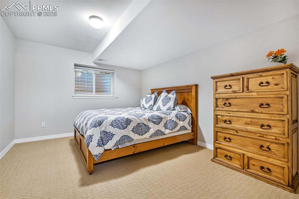 Image 36 of 47: Bedroom with light carpet