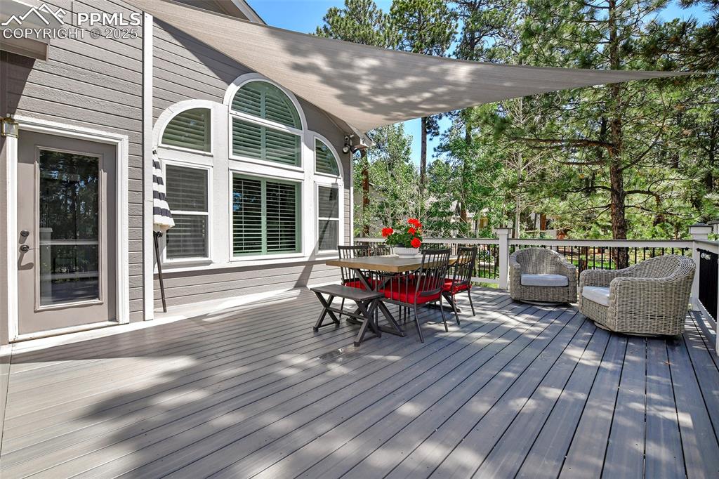 Image 43 of 47: Wooden terrace featuring outdoor dining area