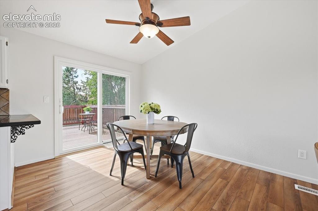 Image 13 of 32: Dining area walks out to new deck through new sliding door!