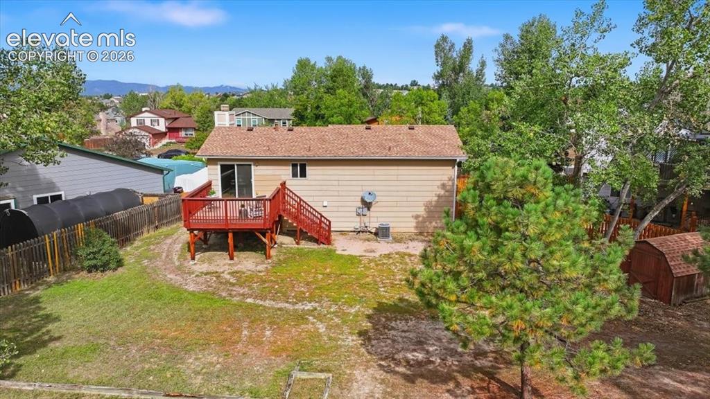 Image 29 of 32: Back of this wonderful home showing the newer deck!