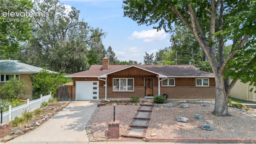 Image 1 of 25: Ranch-style residence featuring a brick and wood siding exterior