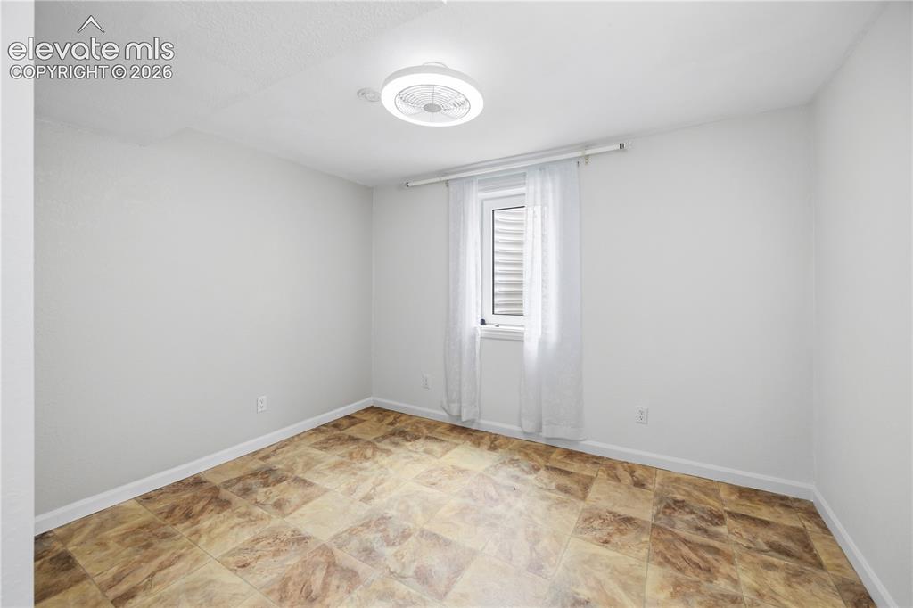 Image 15 of 25: Room featuring a modern ceiling fan with integrated lighting, a window with