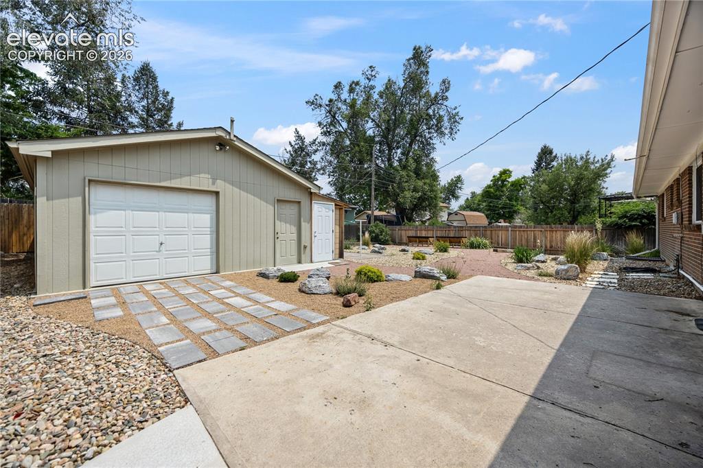 Image 18 of 25: Detached heated garage with electricity and additional storage space—ideal 