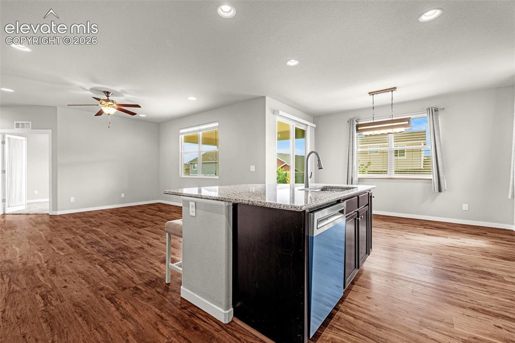 Image 12 of 44: Open-concept living space featuring wood-finish flooring, recessed lighting