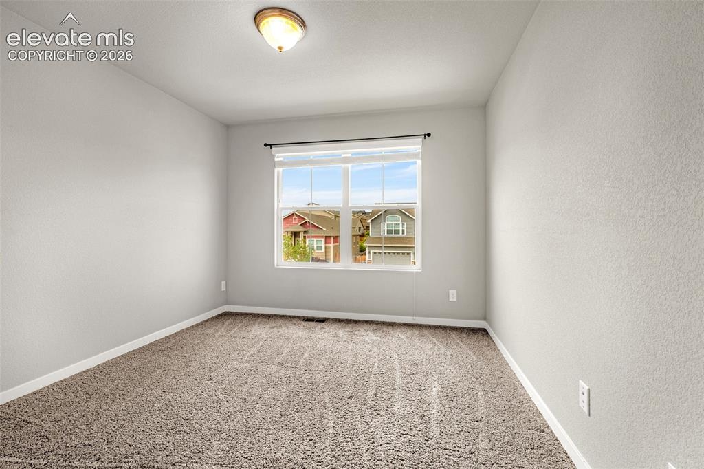 Image 19 of 44: Wall-to-wall carpeting and neutral wall tones