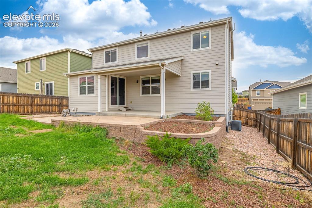 Image 33 of 44: Two-story exterior with light-colored siding