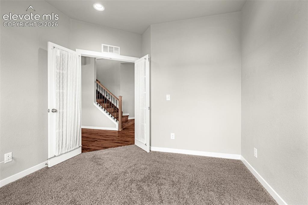 Image 7 of 44: Carpeted room featuring light gray walls, recessed lighting, and white trim