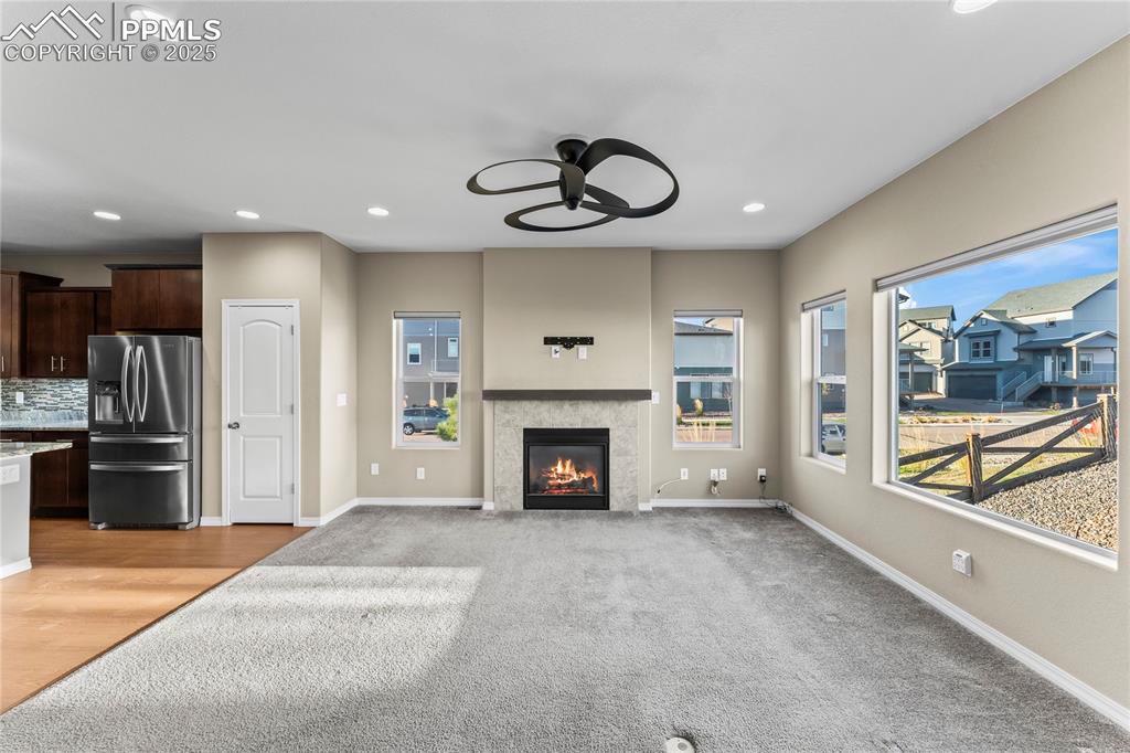 Image 18 of 45: Unfurnished living room featuring recessed lighting, a ceiling fan, a tile 