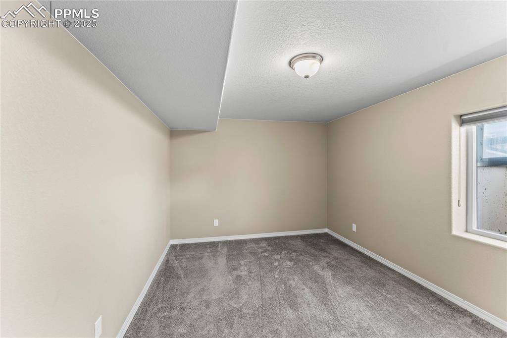 Image 34 of 45: Spare room featuring carpet floors and a textured ceiling