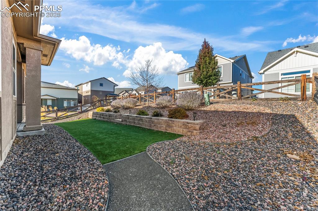 Image 39 of 45: Fenced backyard with a residential view